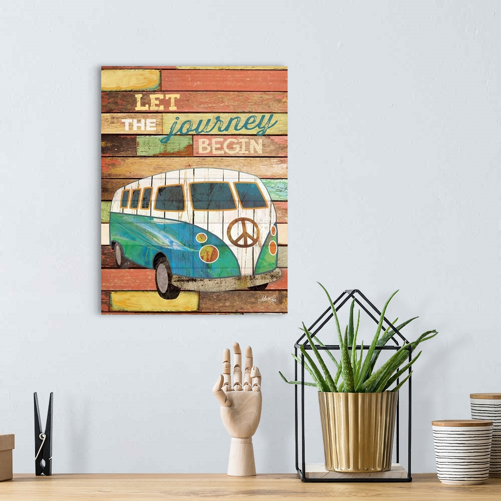 A bohemian room featuring Travel themed typography art with an old van against a distressed wooden surface.