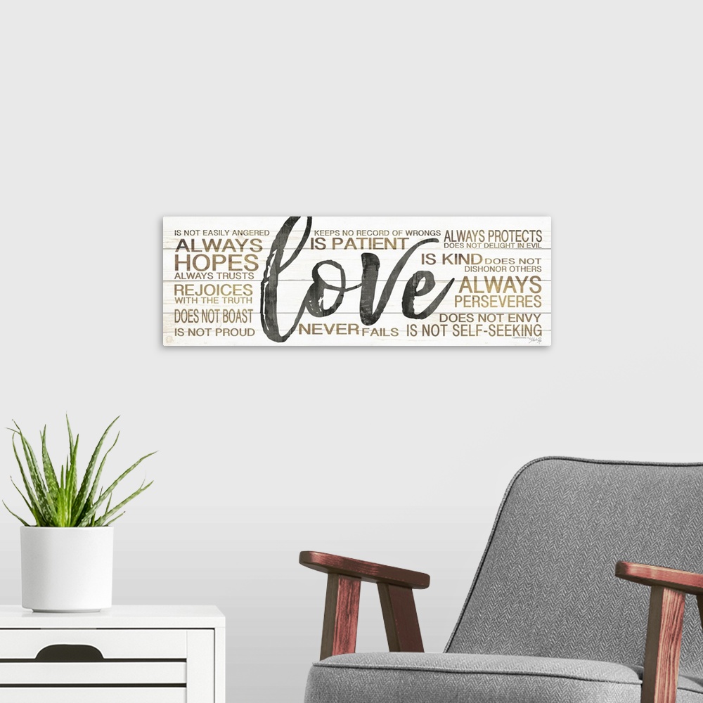 A modern room featuring Typography artwork of the word "love" in large black script, surrounded by 1 Corinthians 13:4.