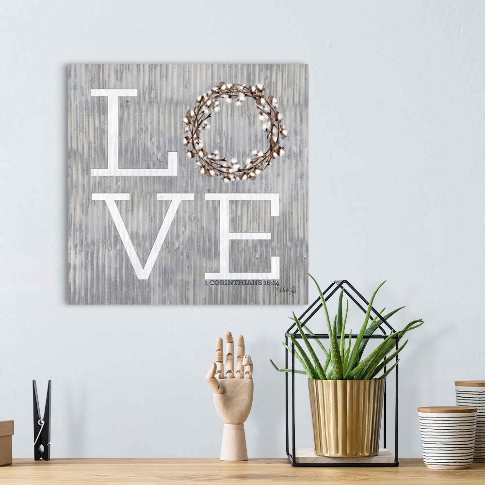 A bohemian room featuring "Love" with a wreath on a weathered metal background.