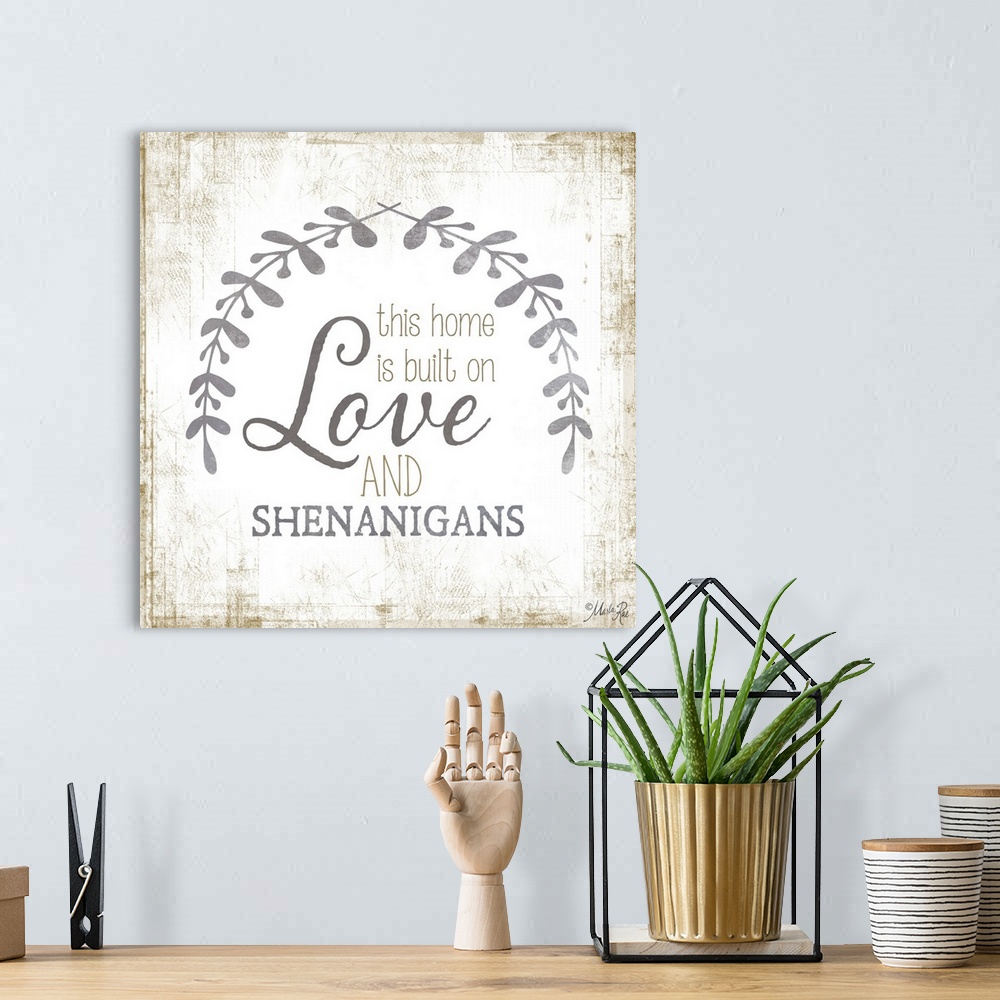 A bohemian room featuring Phrase about family love framed by two leafy sprigs on a textured background.
