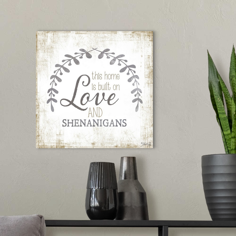 A modern room featuring Phrase about family love framed by two leafy sprigs on a textured background.