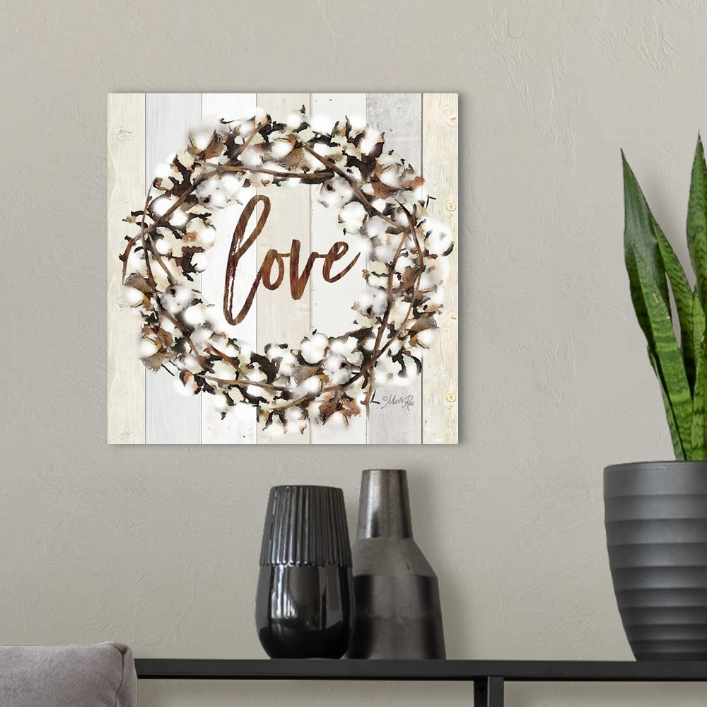 A modern room featuring "Love" in the middle of a wreath of cotton against a shiplap background.