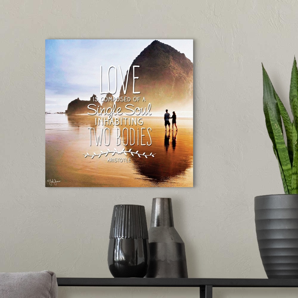 A modern room featuring Sentiment in white lettering against a photograph of a silhouetted couple walking along a beach.