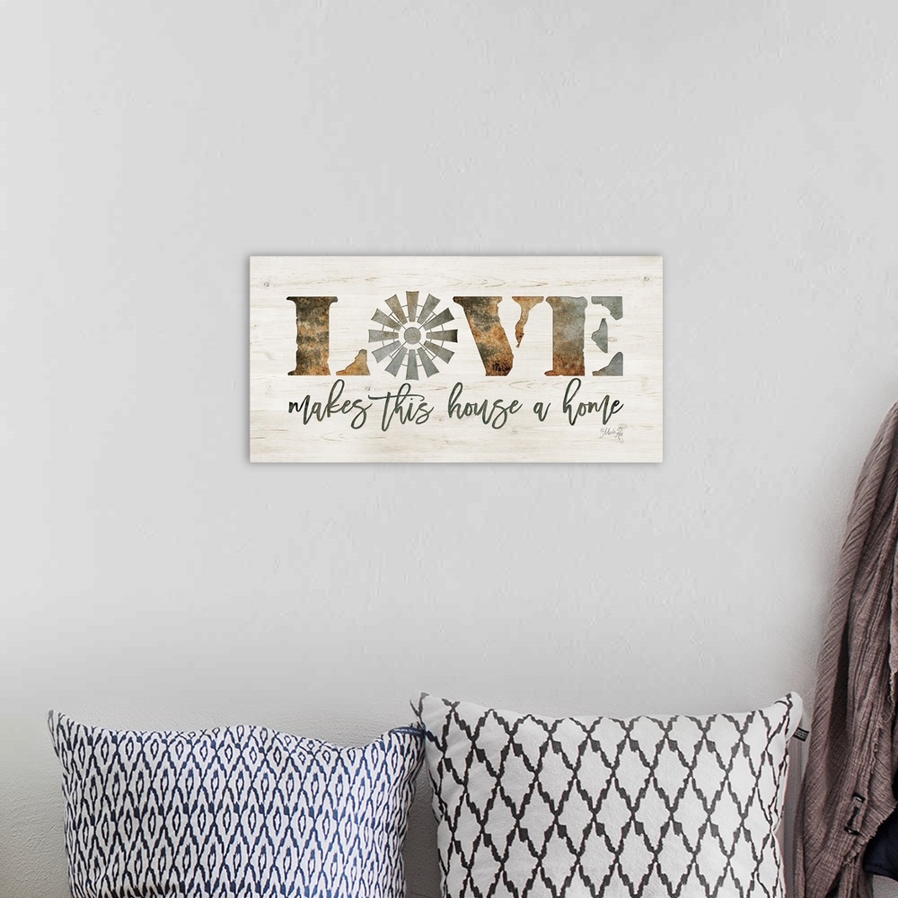 A bohemian room featuring "Love makes This House a Home" on a white washed wood background.