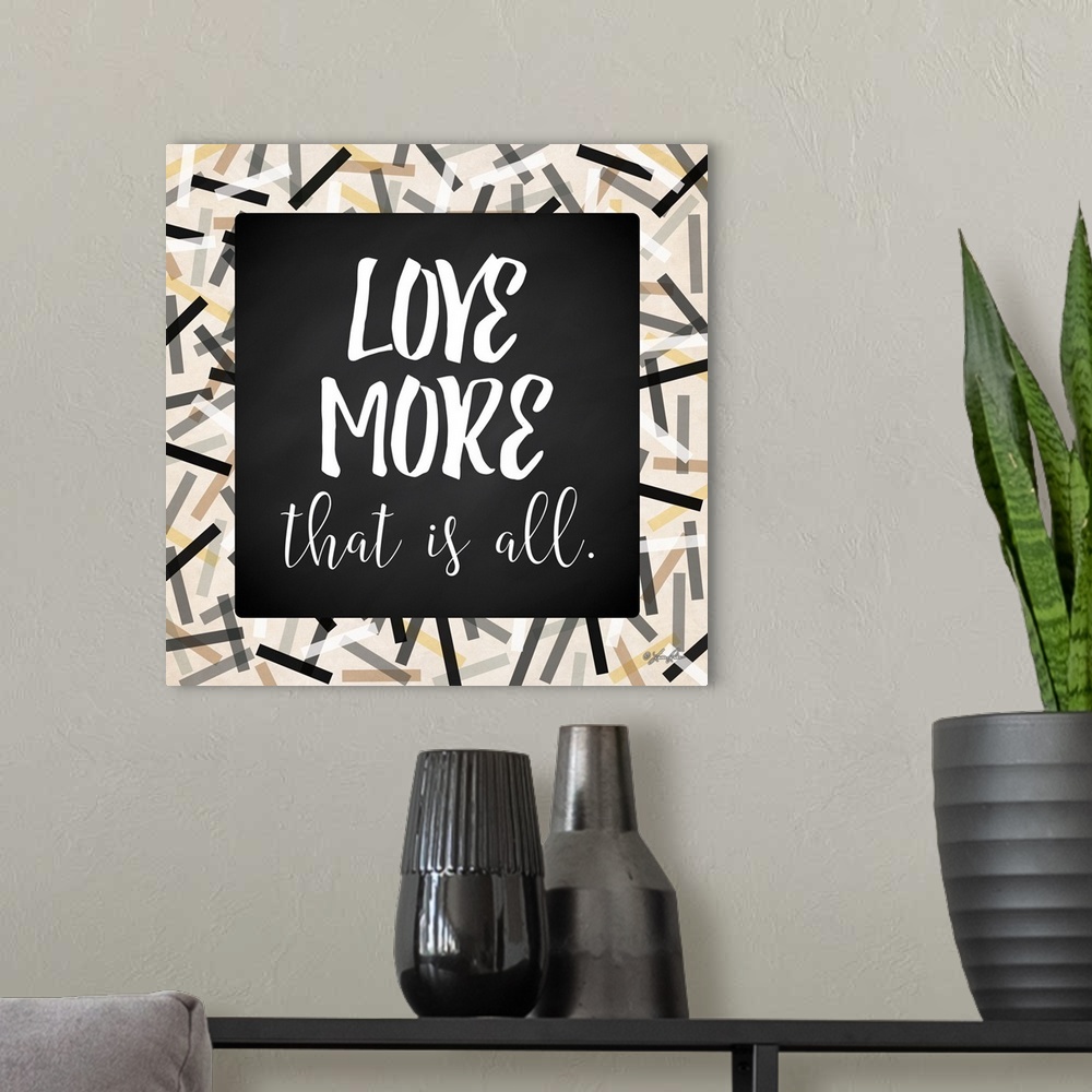 A modern room featuring Inspirational typography art in black and white with a festive frame.