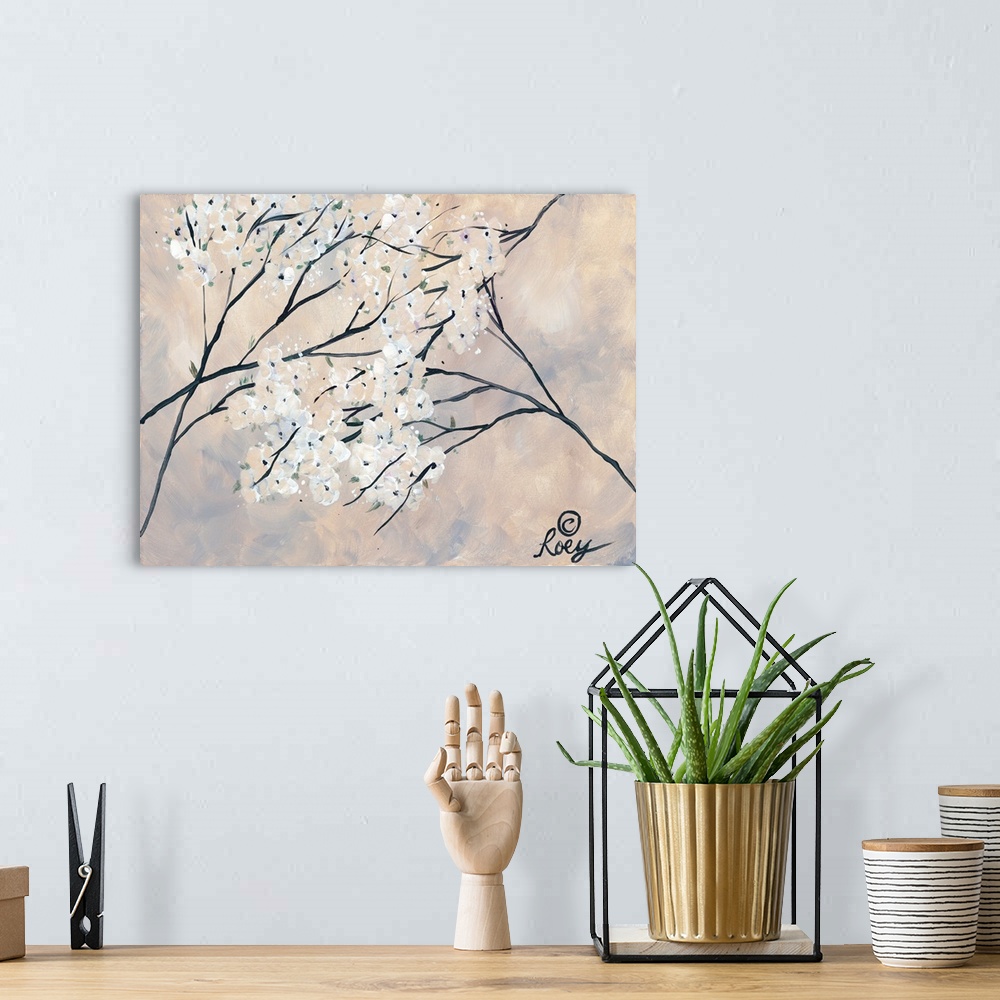 A bohemian room featuring Artwork of magnolia branches with blooming white flowers on a pale hazy background.