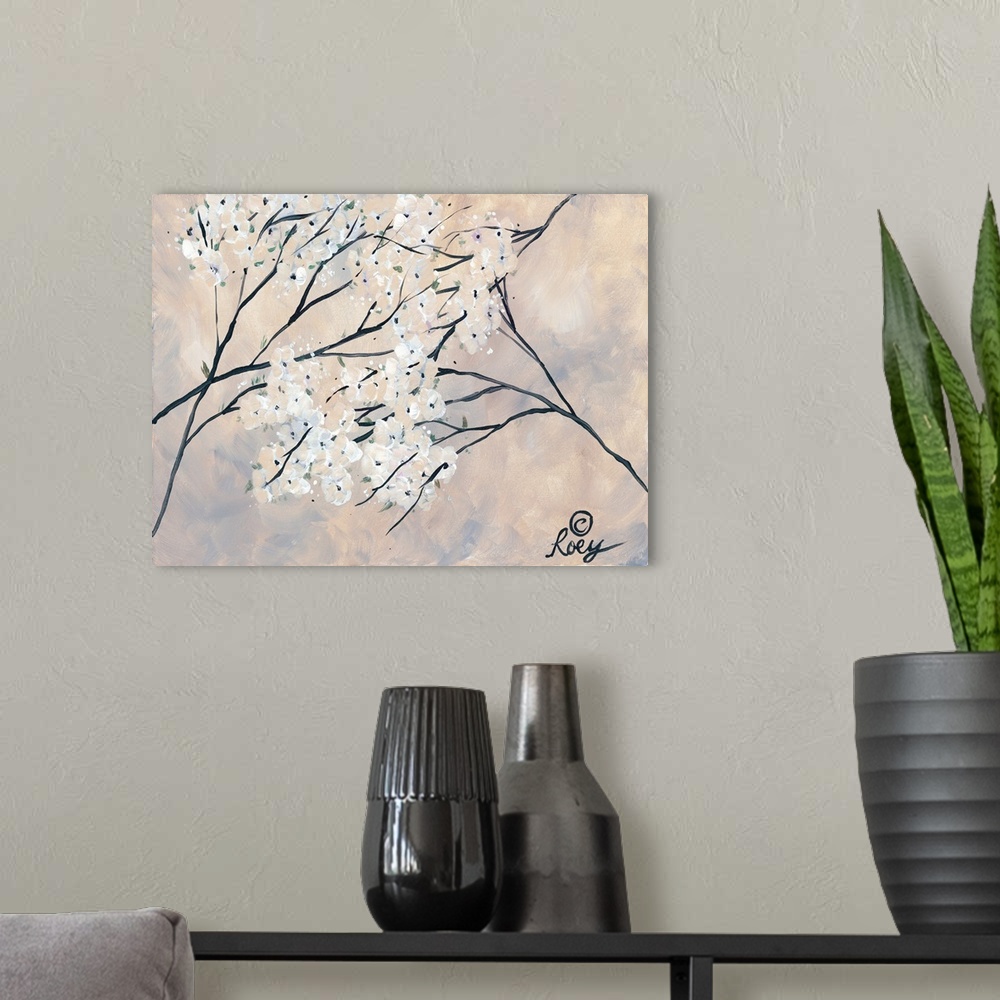 A modern room featuring Artwork of magnolia branches with blooming white flowers on a pale hazy background.