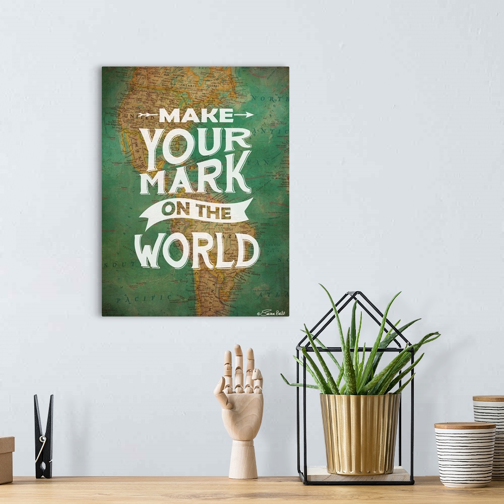 A bohemian room featuring Inspirational quote in white lettering against a photograph of a world map.