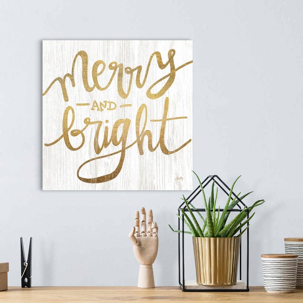 A bohemian room featuring The words merry and bright are gold colored letters over white background with wood grain texture...