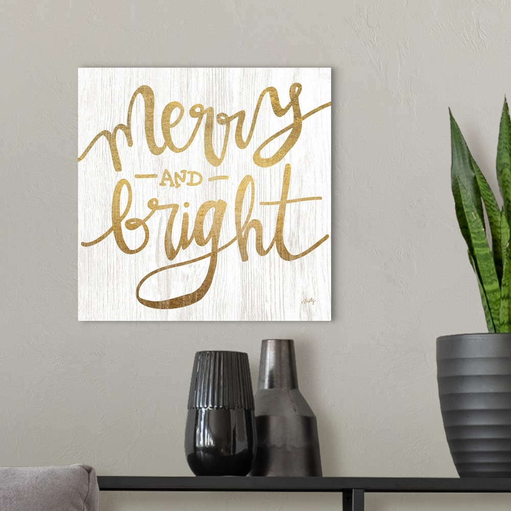 A modern room featuring The words merry and bright are gold colored letters over white background with wood grain texture...