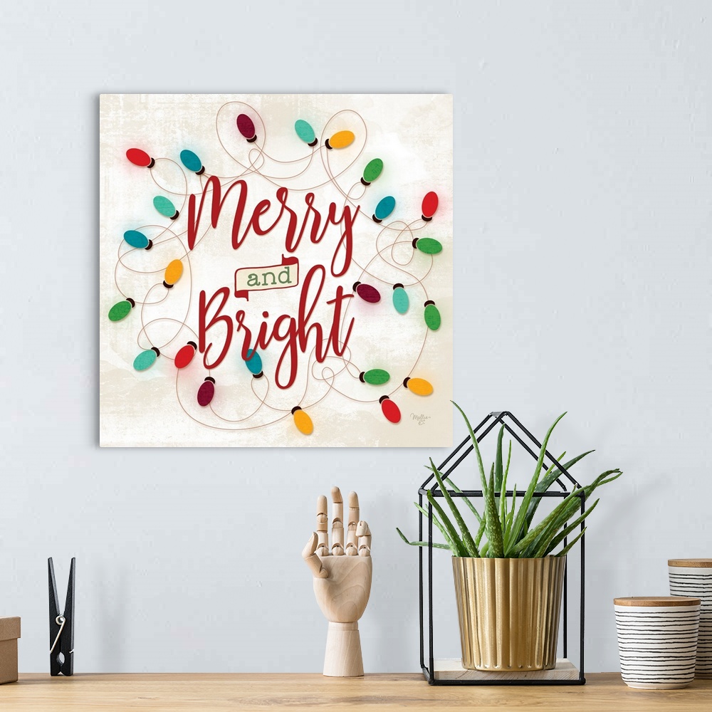 A bohemian room featuring Decorative artwork with festive string lights surrounding the words: Merry and Bright.