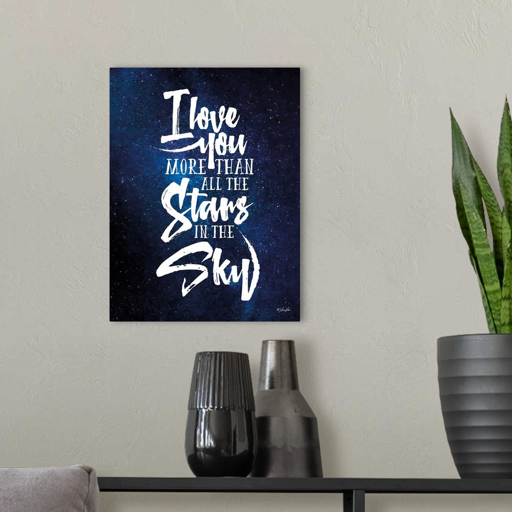 A modern room featuring Handlettered artwork reading "I love you more than all the stars in the sky" over an image of a s...