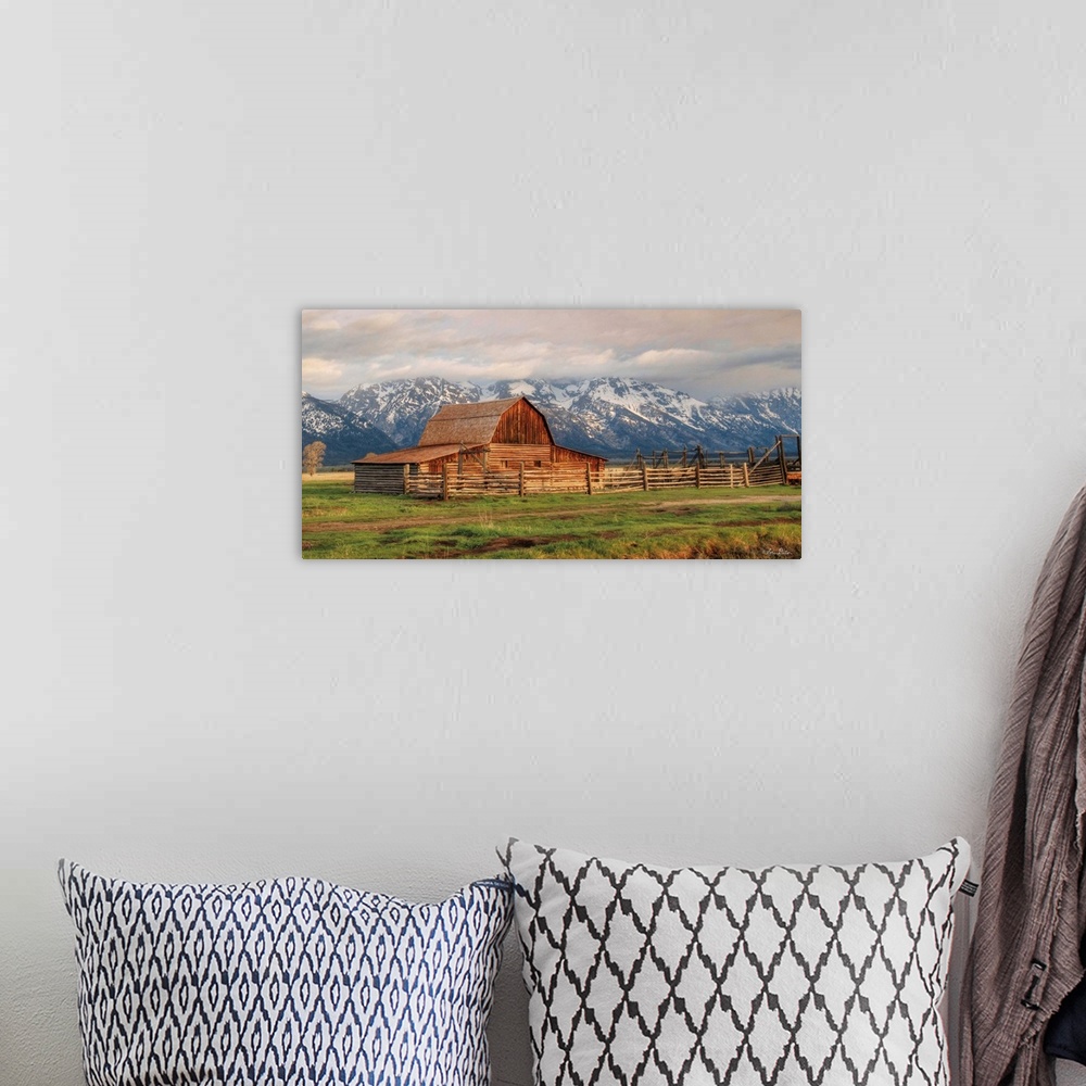 A bohemian room featuring The famous Mormon Barn in Wyoming at the base of the Grand Teton Mountains.
