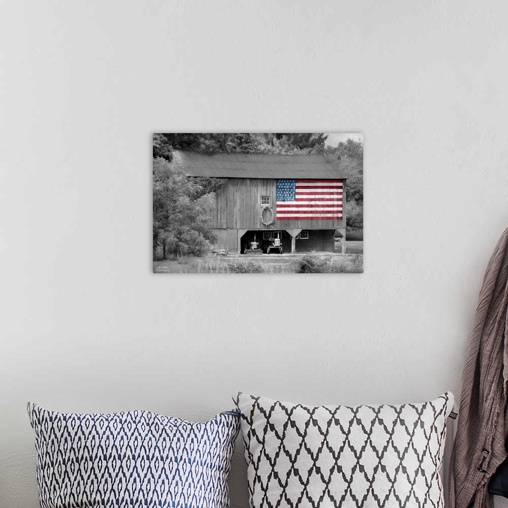 A bohemian room featuring Black and white photo of a barn with an American Flag in color painted on the side.