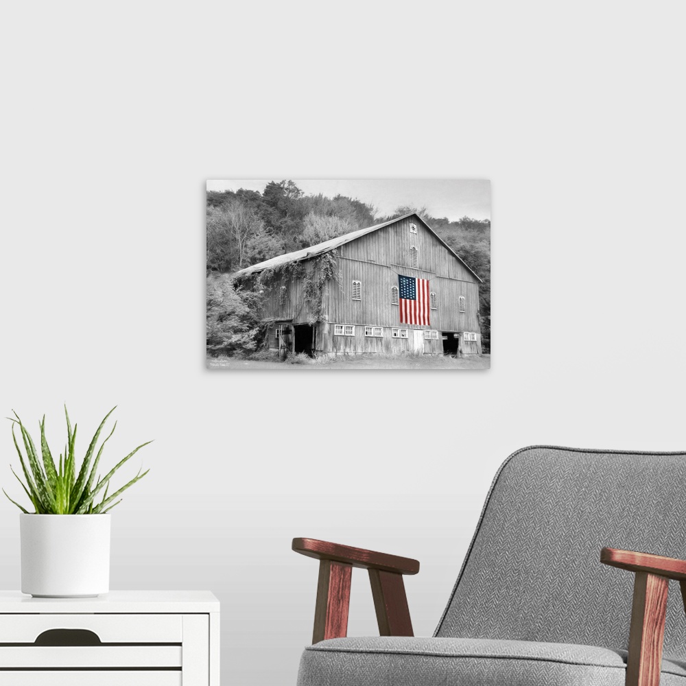 A modern room featuring Black and white photo of a barn with an American Flag in color hanging on the side.