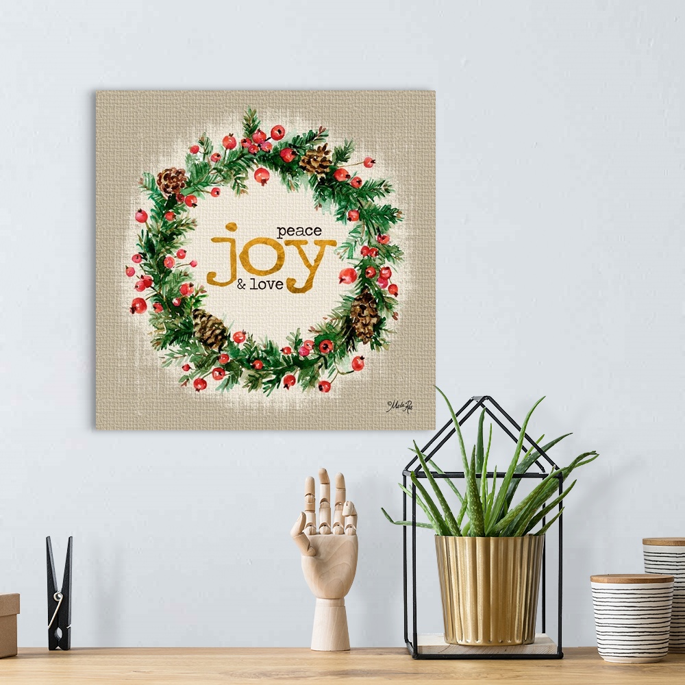 A bohemian room featuring Christmas themed artwork decorated with holly berries and pine branches with gold text.