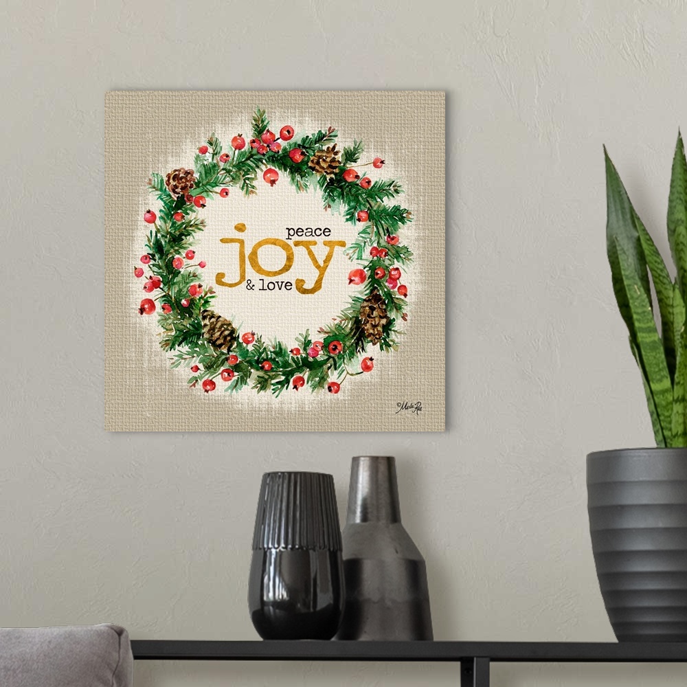 A modern room featuring Christmas themed artwork decorated with holly berries and pine branches with gold text.