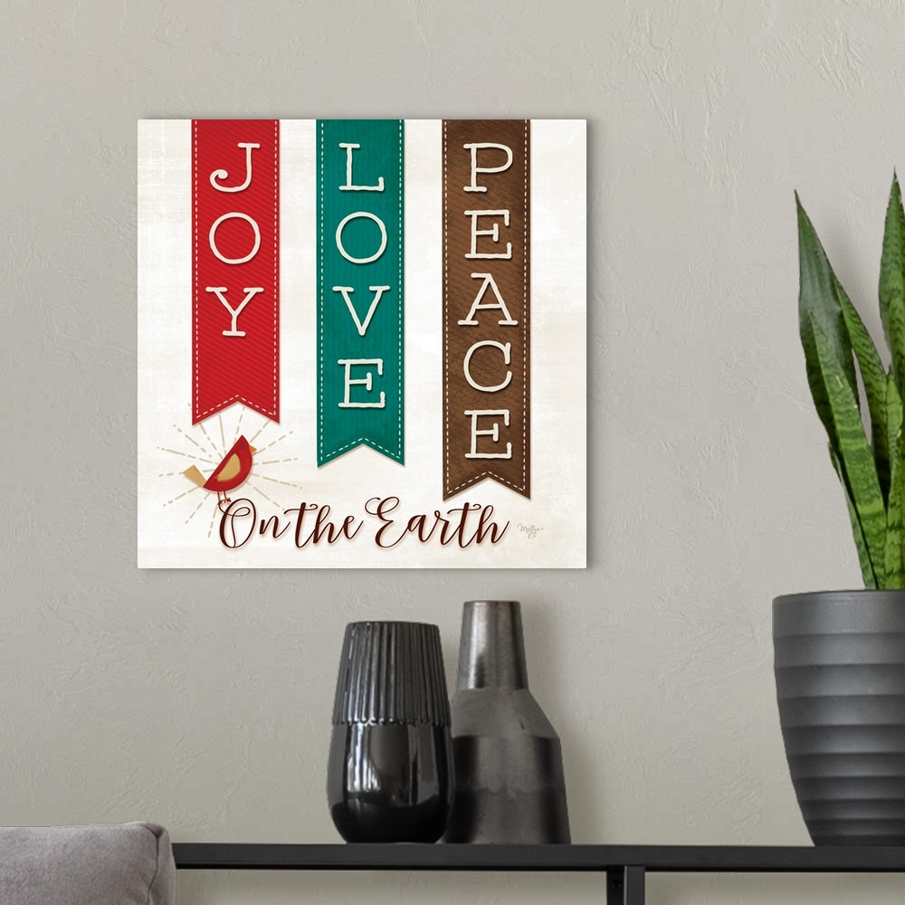 A modern room featuring This decorative artwork features festive banners with the words: Joy, Love, and Peace. Underneath...