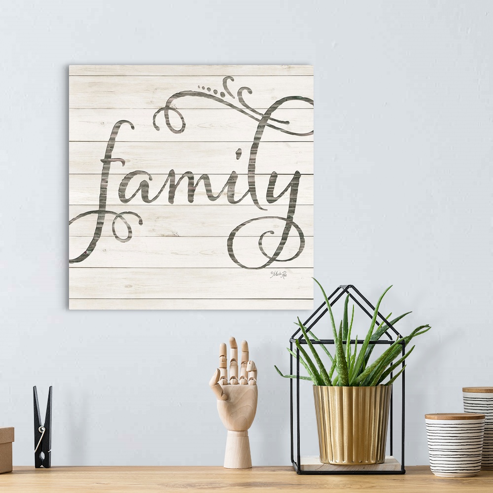 A bohemian room featuring "Family" situated on a white shiplap background.