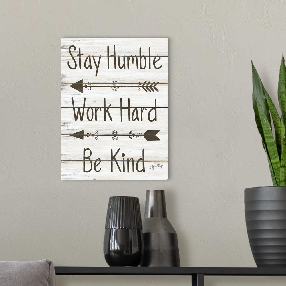 A modern room featuring This decorative artwork features the phrase: Stay humble, work hard, be kind, over a distressed w...