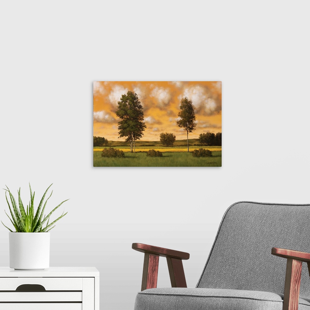 A modern room featuring Painting of two tall trees in a field against an orange sunset sky.