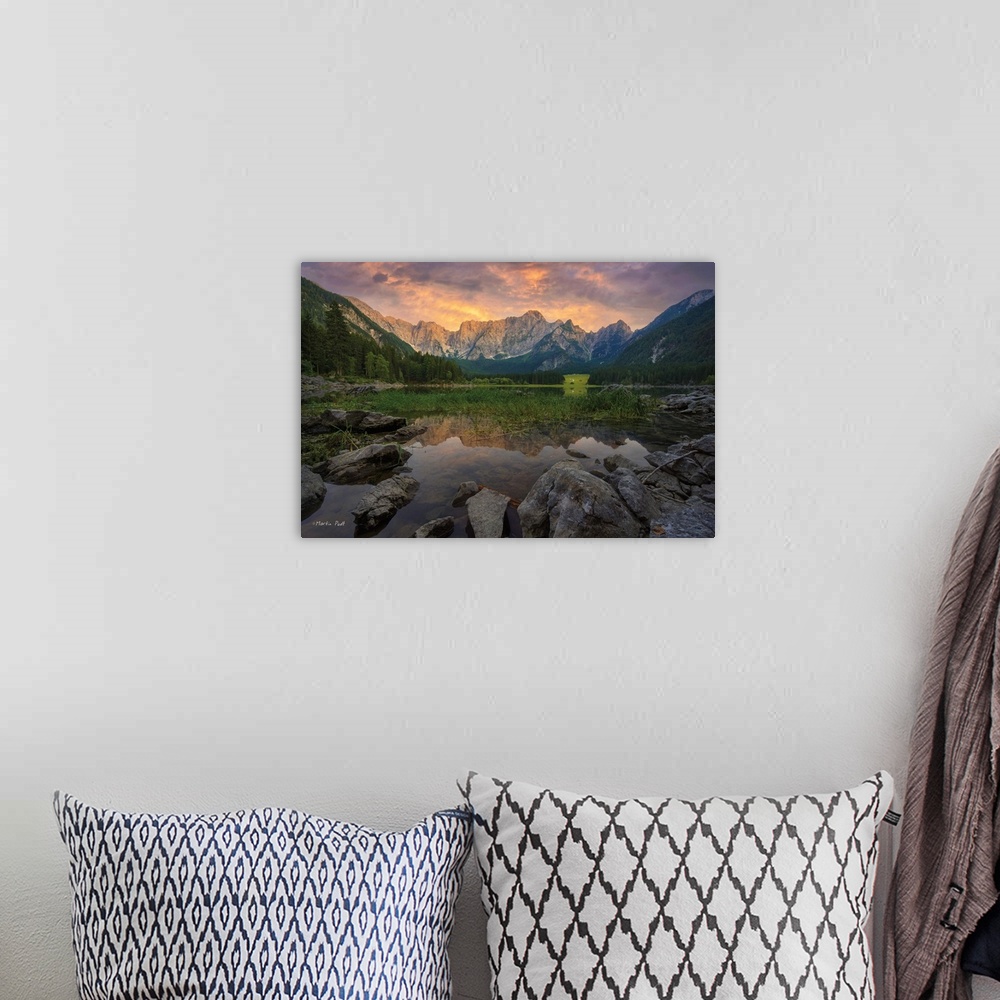 A bohemian room featuring Photo of a calm mountain lake under clouds glowing in sunset light.