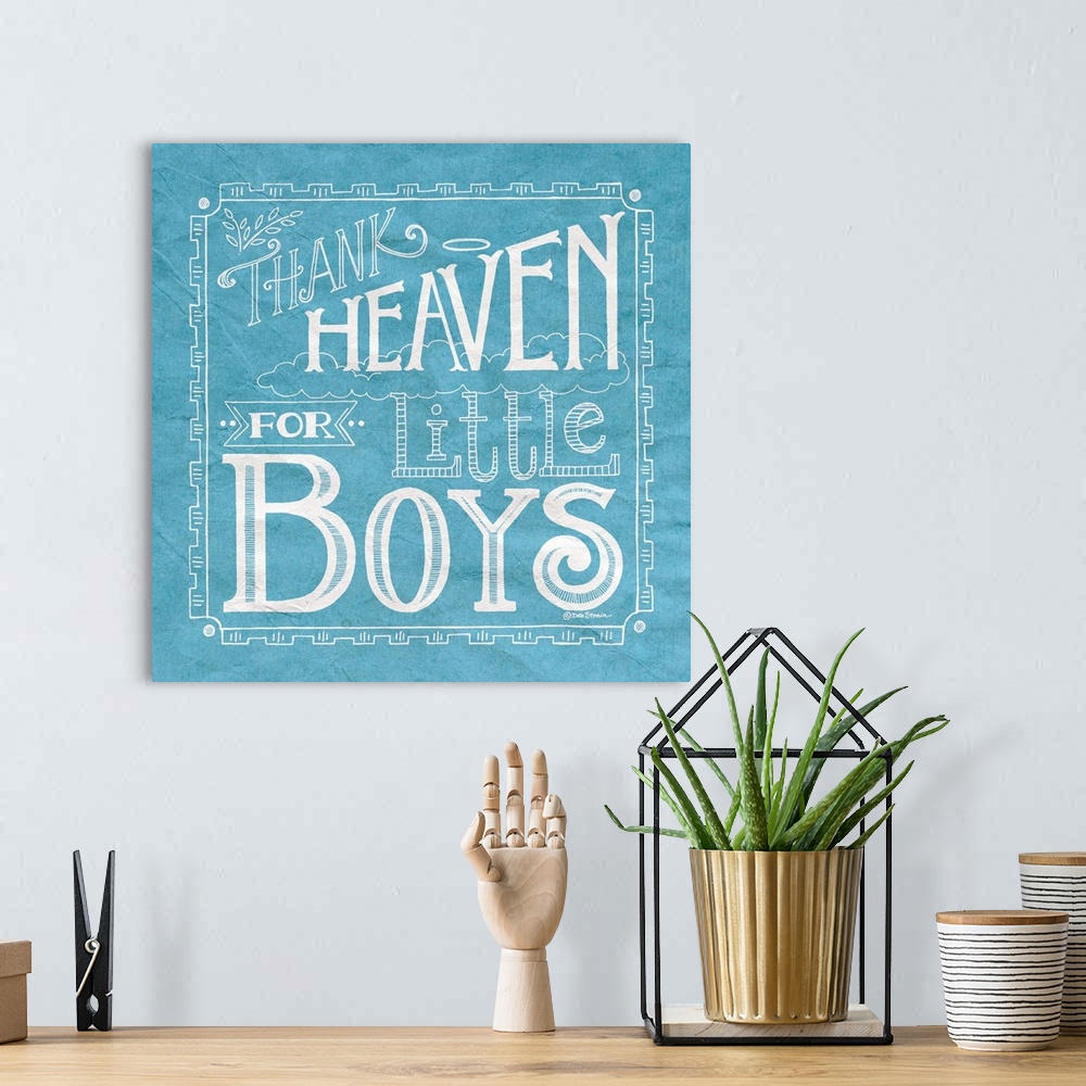 A bohemian room featuring Handlettered home decor art for a boy's room, with white lettering against a distressed blue back...