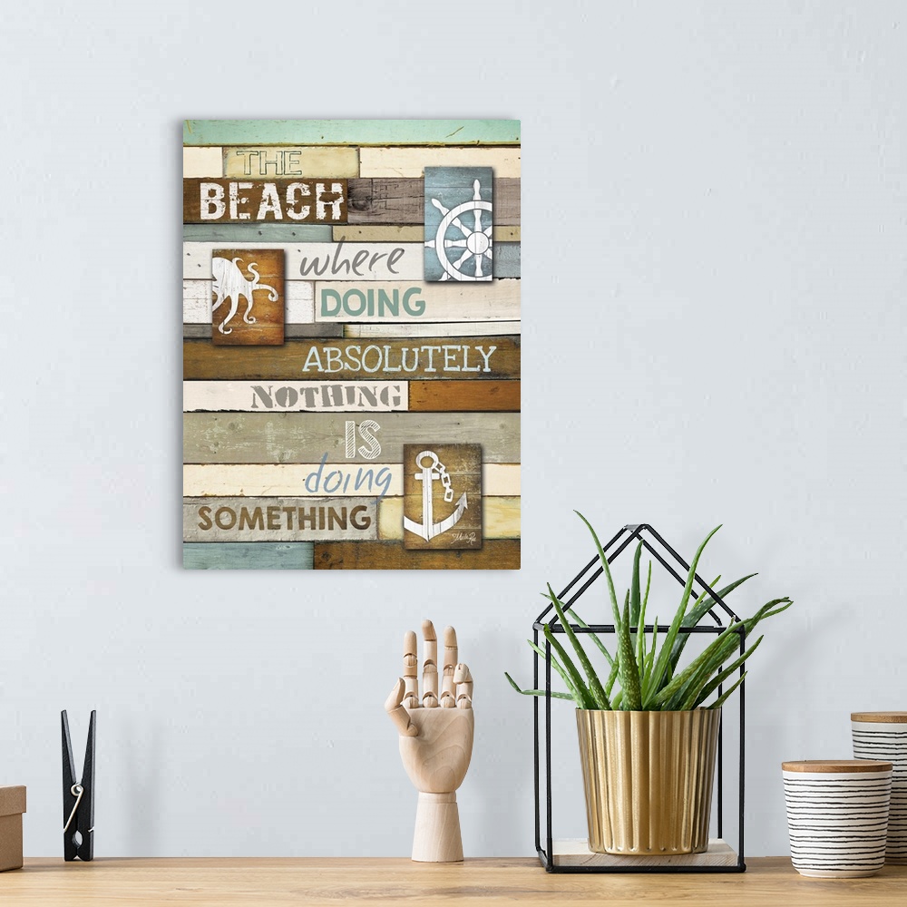 A bohemian room featuring Cute coastal typography art on wooden boards with an anchor and octopus.