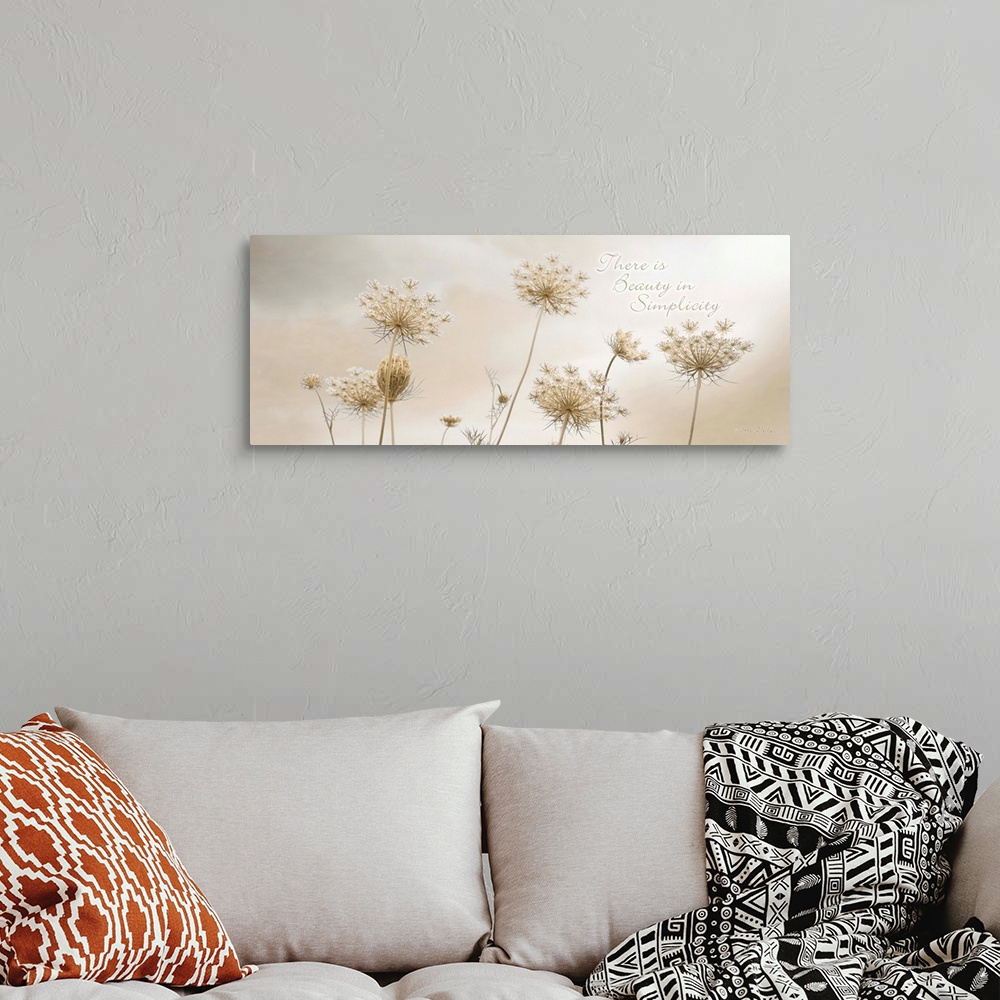 A bohemian room featuring Decorative artwork featuring flowers with the words: There is beauty in simplicity, above it.