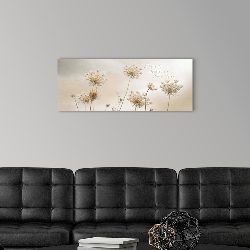 A modern room featuring Decorative artwork featuring flowers with the words: There is beauty in simplicity, above it.
