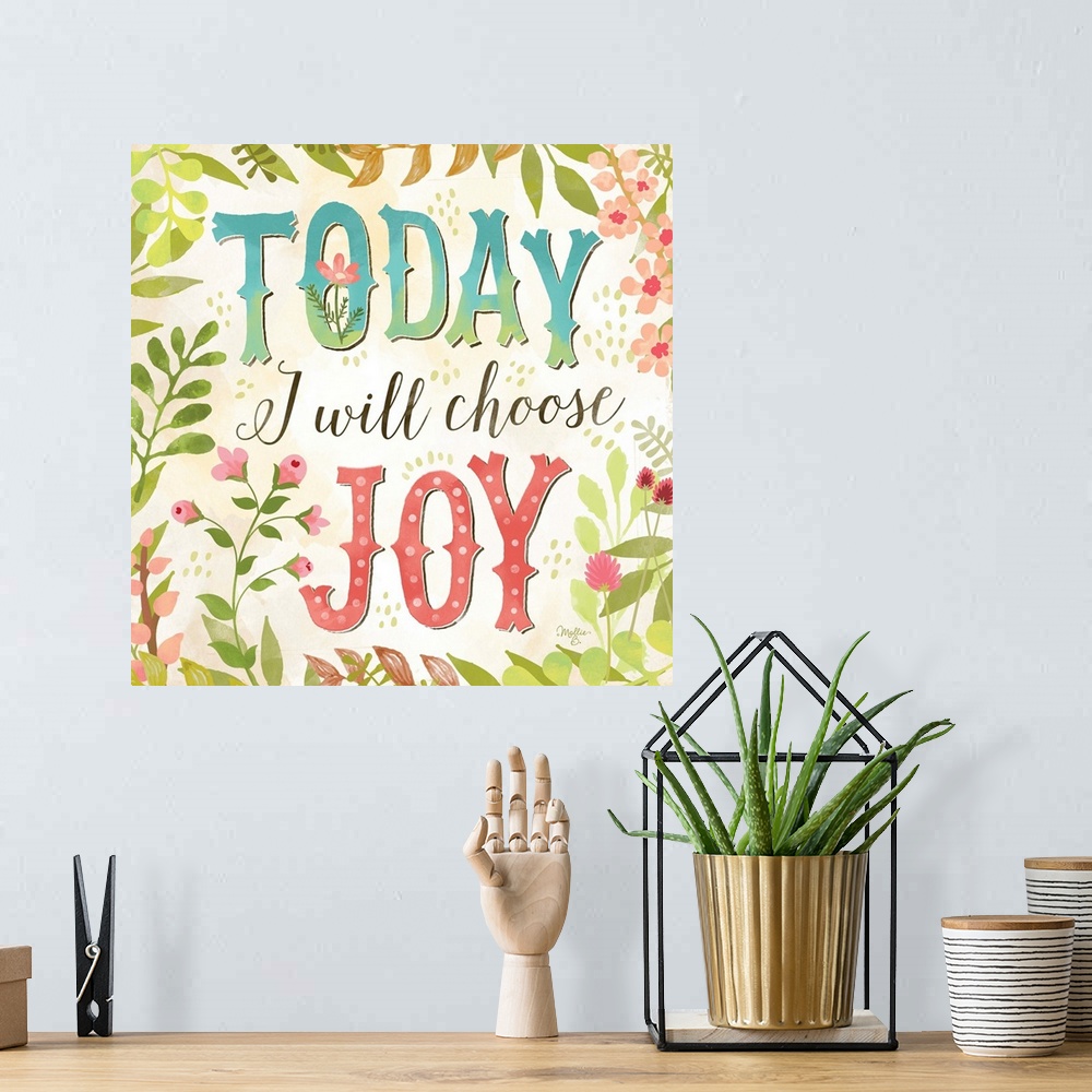A bohemian room featuring Brightly colored hand-lettered typography art framed with flowers and leaves.