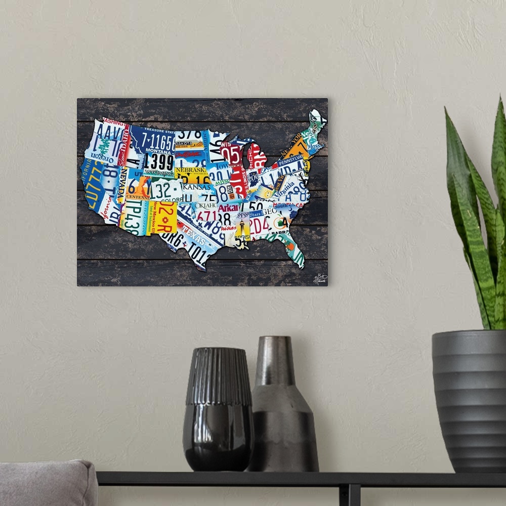 A modern room featuring Map of the USA made from different license plates, against a dark wood planked background.