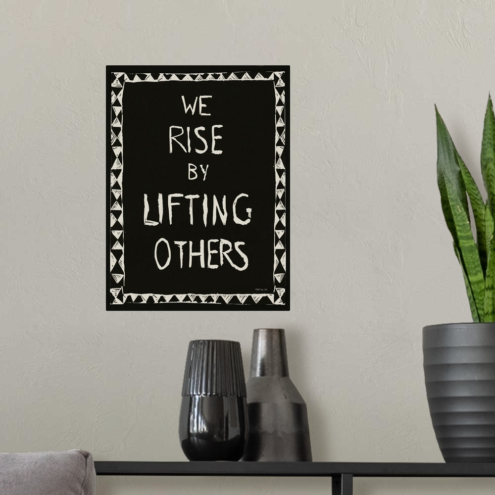 A modern room featuring We Rise By Lifting Others