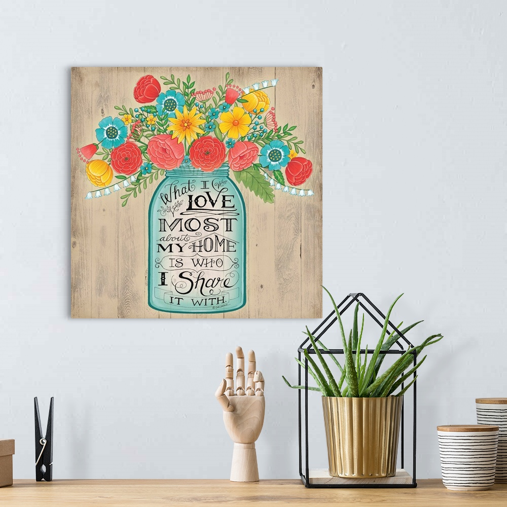 A bohemian room featuring A bouquet of colorful flowers in a mason jar with decorative lettering.