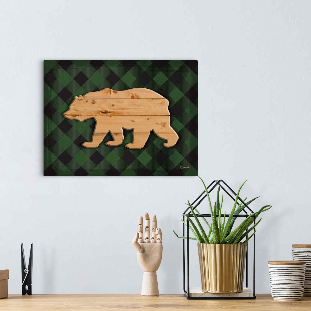A bohemian room featuring Silhouette of a bear with a wooden appearance over a green plaid background.