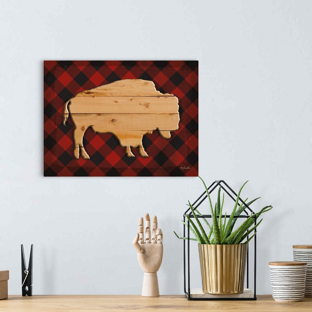 A bohemian room featuring Silhouette of a buffalo with a wooden appearance over a red plaid background.