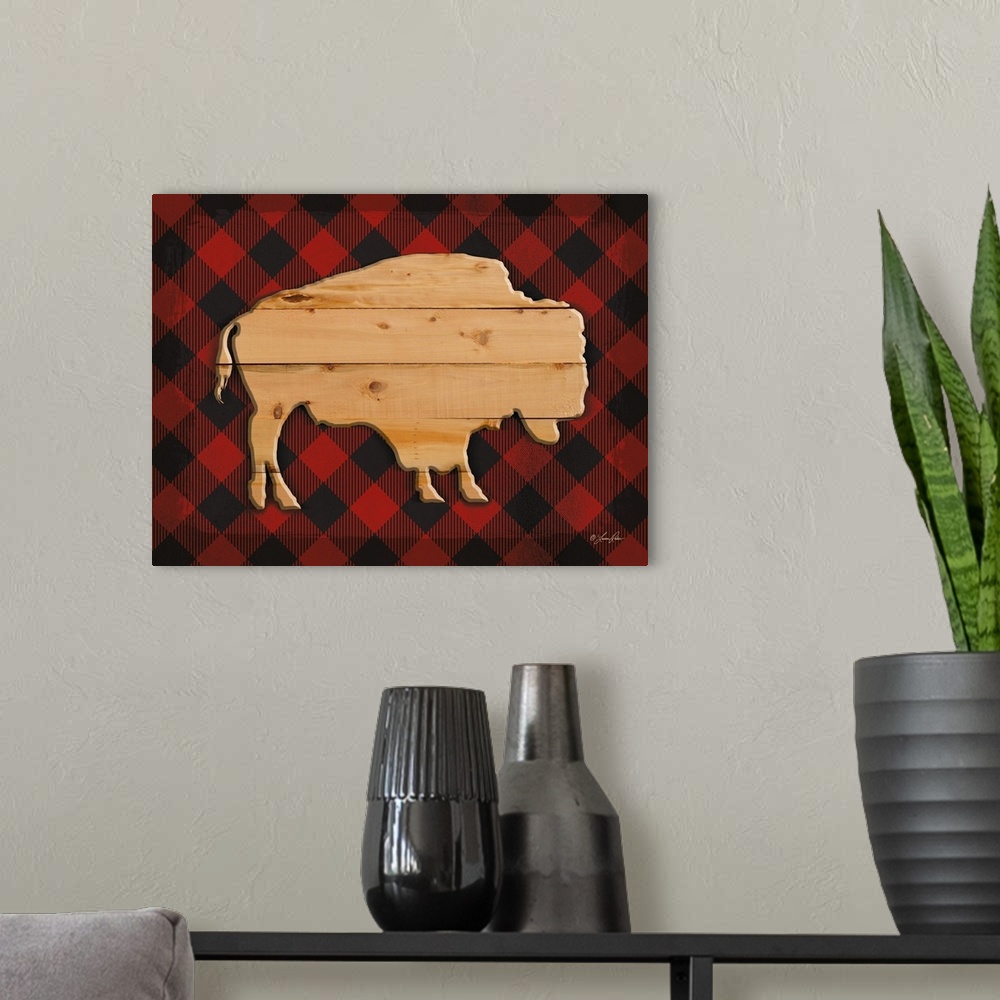 A modern room featuring Silhouette of a buffalo with a wooden appearance over a red plaid background.