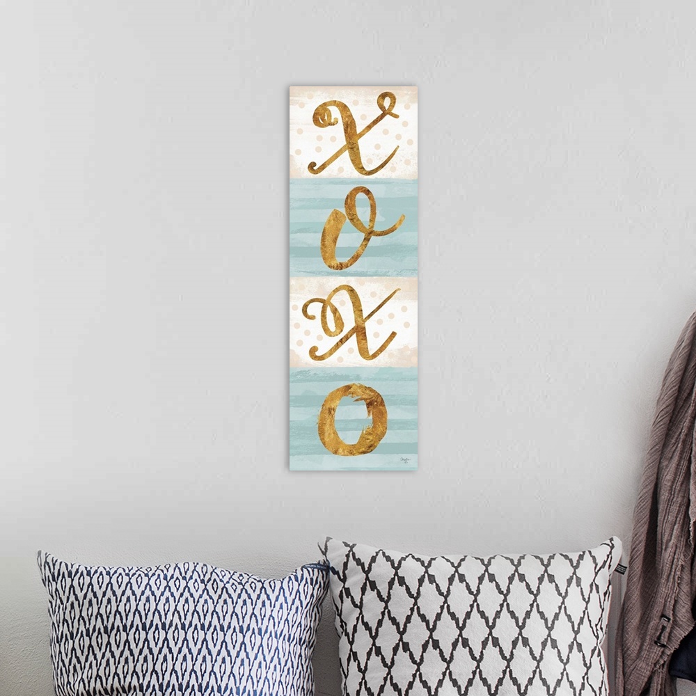 A bohemian room featuring Gold lettering on pale blue and white.
