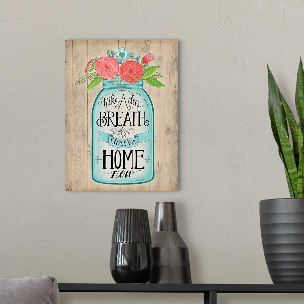 A modern room featuring A bouquet of colorful flowers in a mason jar with decorative lettering.