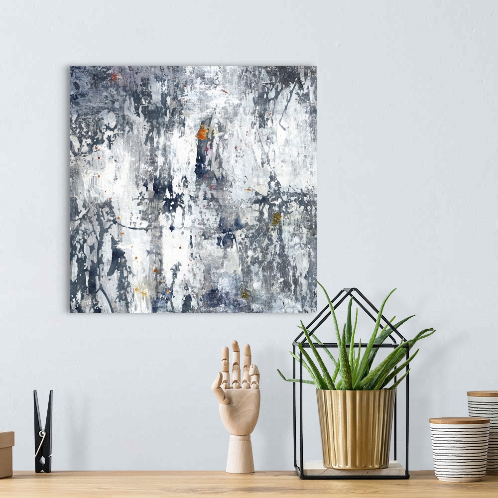 A bohemian room featuring Large gray, white, and indigo abstract art with hints of orange, yellow, and gold throughout.
