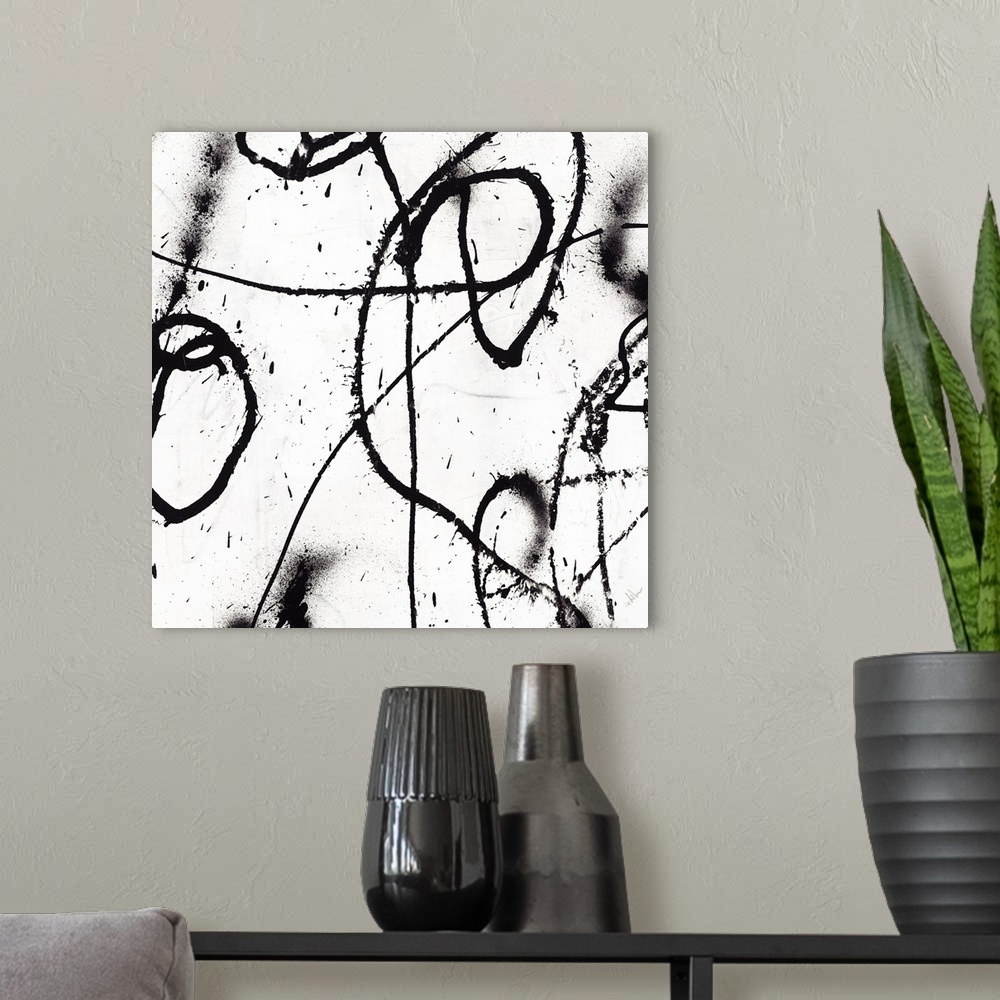 A modern room featuring Black and white abstract painting of black strokes of paint in wandering directions.