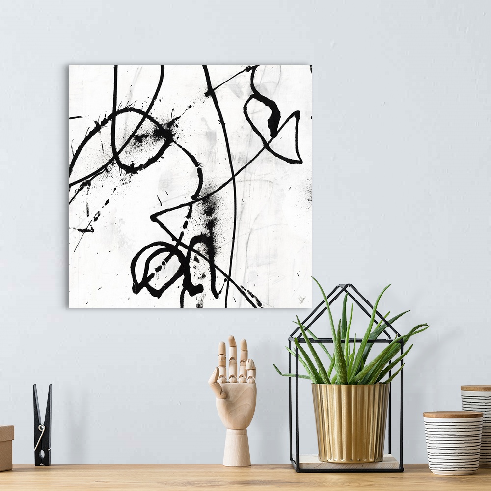 A bohemian room featuring Black and white abstract painting of black strokes of paint in wandering directions.