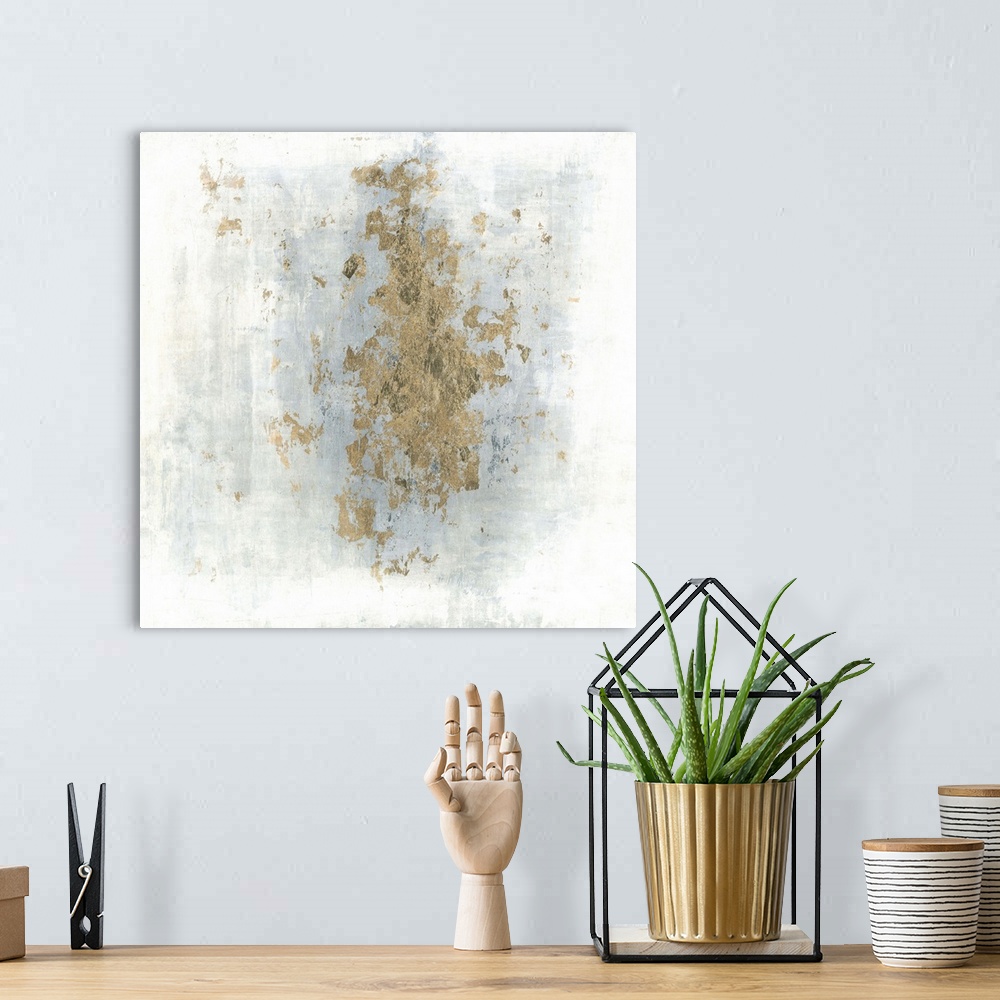 A bohemian room featuring Square abstract art with a cloudy blue and white background and gold foil center.