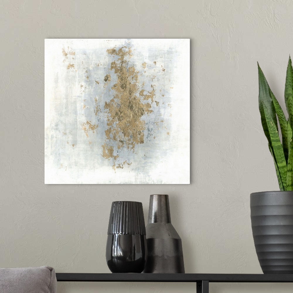 A modern room featuring Square abstract art with a cloudy blue and white background and gold foil center.