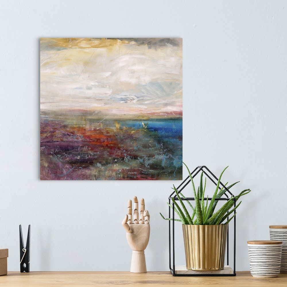 A bohemian room featuring Abstract painting of a golden cloudy sky above a vibrant field of wildflowers and a deep blue bod...