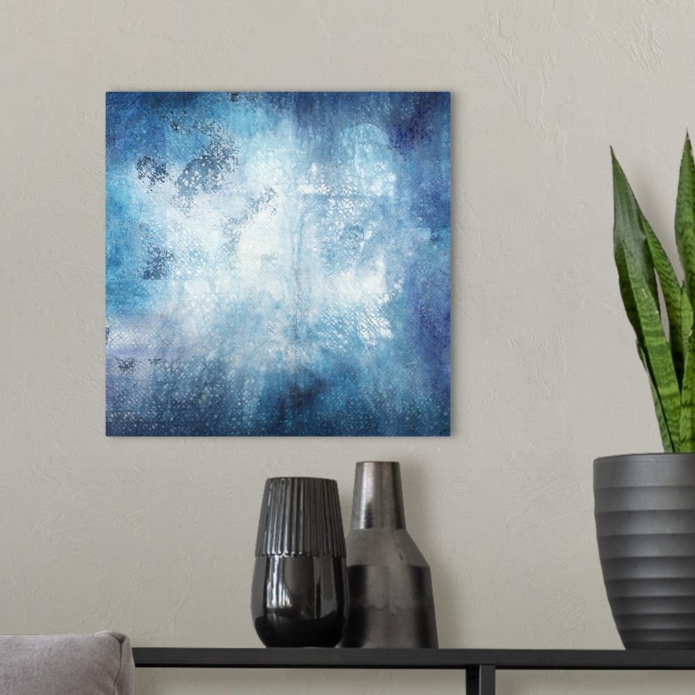 A modern room featuring Square abstract art in shades of blue with lined texture coming through.