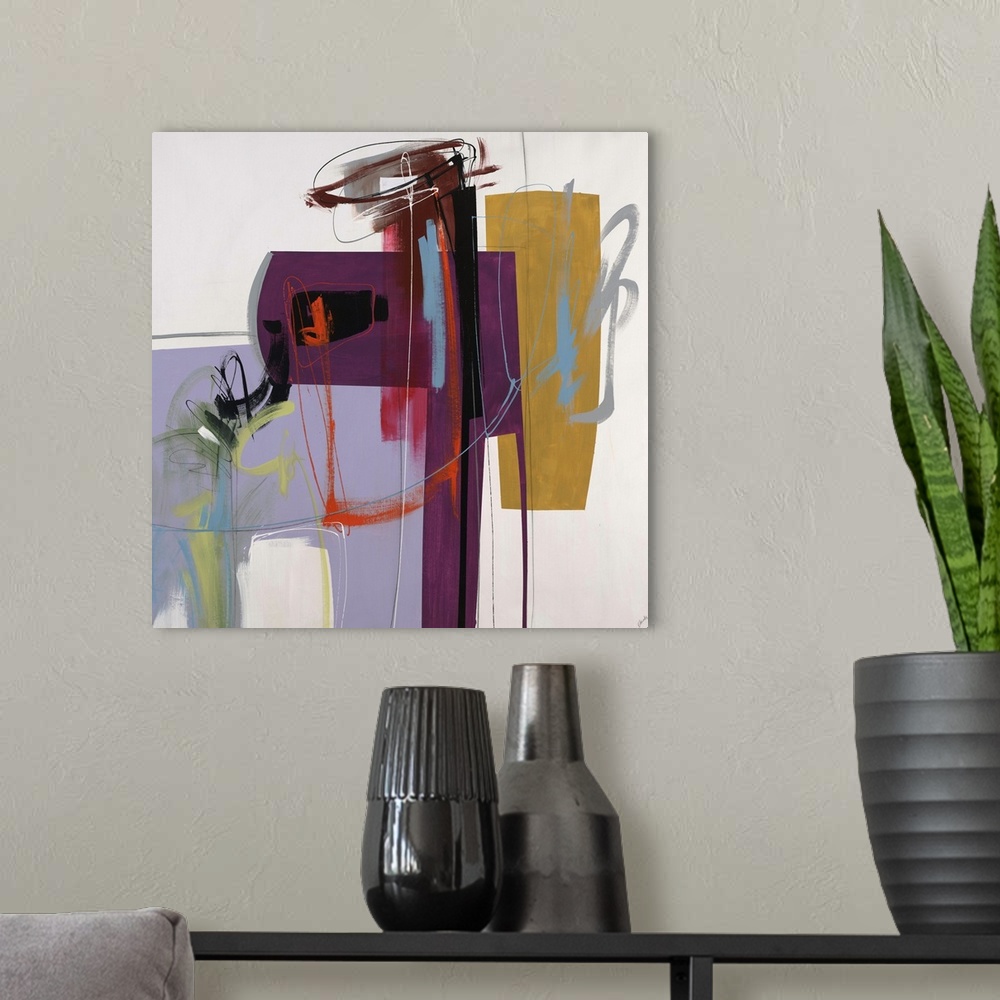 A modern room featuring Abstract painting using vibrant colors in different different shapes against a neutral background.