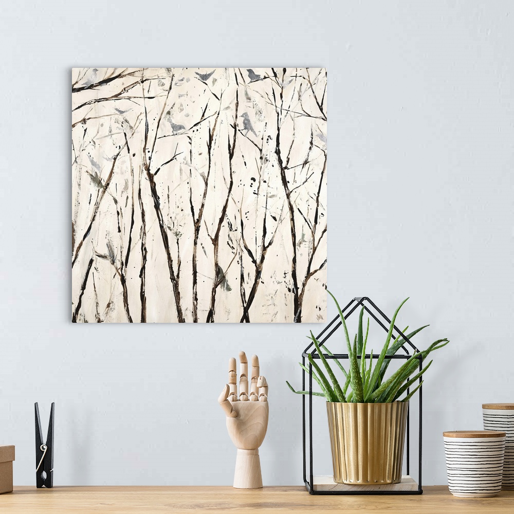 A bohemian room featuring Square painting in neutral white and brown hues with silver birds perched on bare branches.
