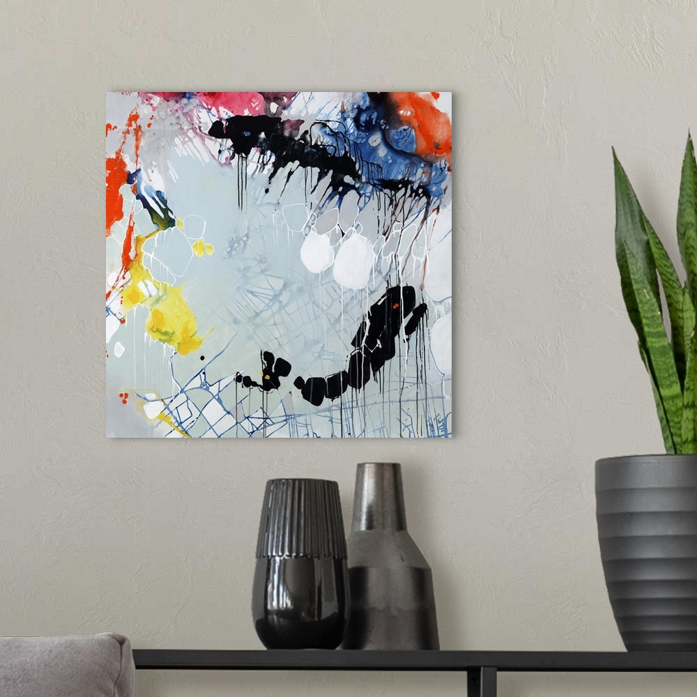 A modern room featuring Colorful splatter abstract painting  with circular shapes, blue grid lines, and paint dripping th...
