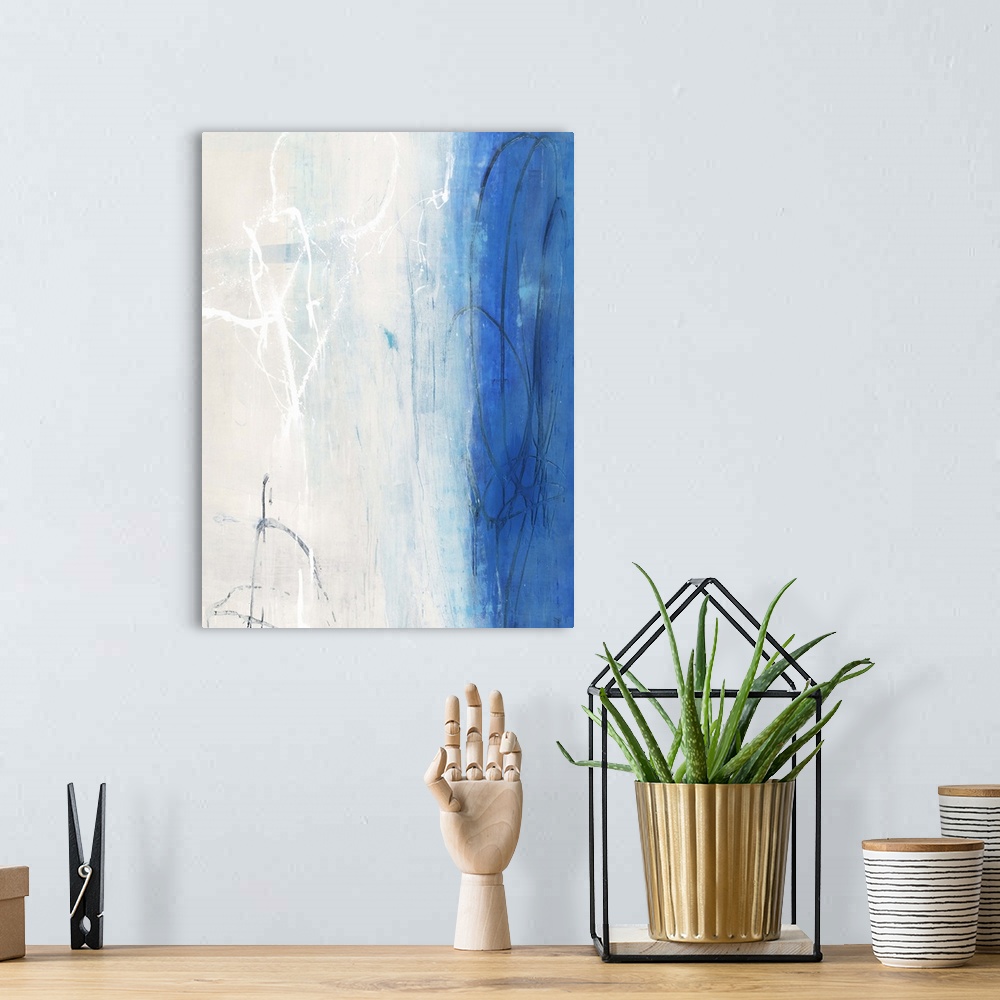 A bohemian room featuring Contemporary abstract painting using white and vibrant blue in vertical formation.